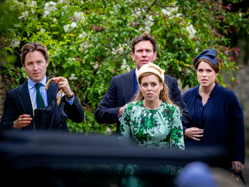 Princess Beatrice in a green floral dress and her husband Edoardo Mapelli Mozzi with Princess Eugenie and Jack Brooksbank exiting a car.