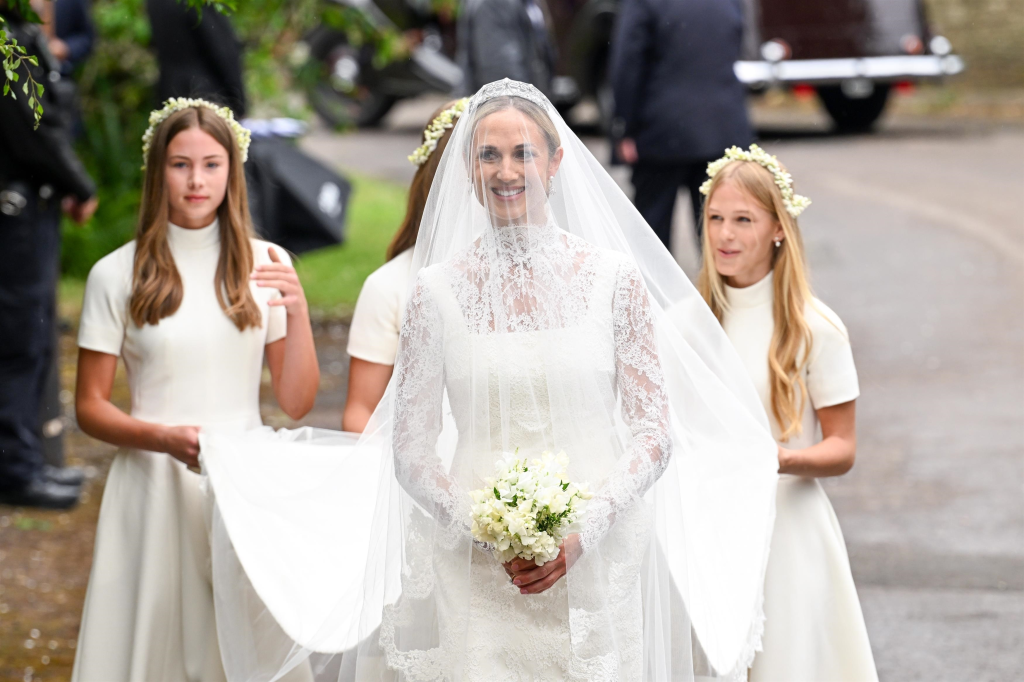 Harriet Sperling, in a lace wedding dress and veil, with her bridesmaids Georgina Sperling, Savannah Phillips, and Isla Phillips, at All Saints' Church.