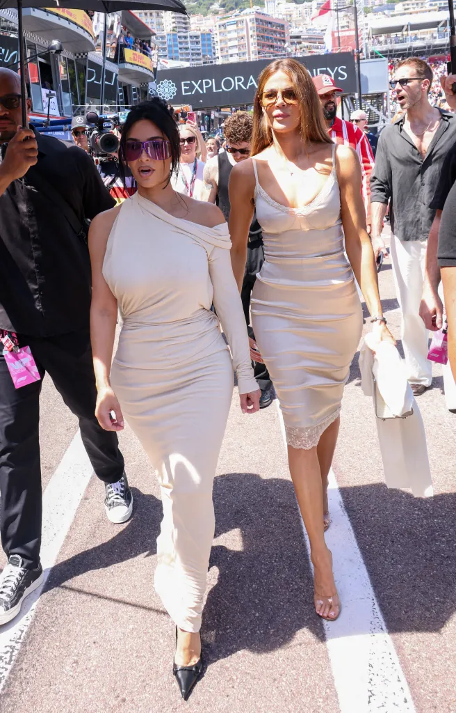 Kim and Khloe Kardashian, with their security team, walk through the paddock at the F1 Louis Vuitton Grand Prix de Monaco.