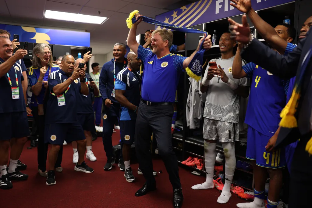 King Willem-Alexander of the Netherlands celebrating with Curacao players in the dressing room after their FIFA World Cup 2026 match.