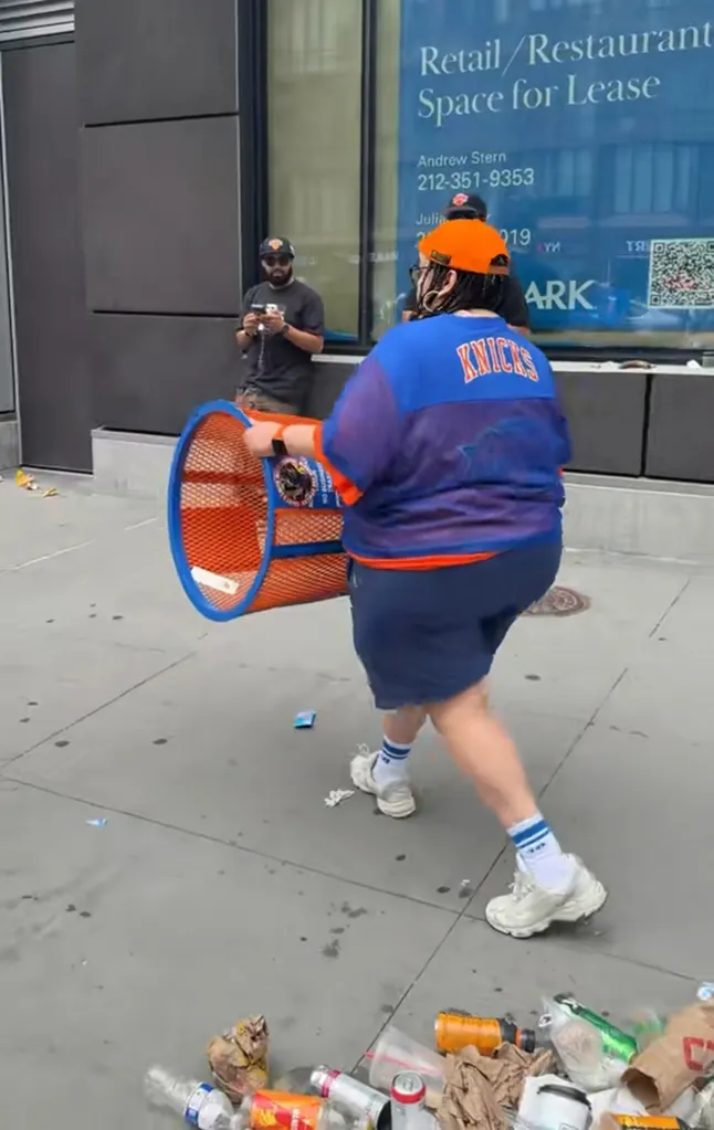 woman stealing trash can