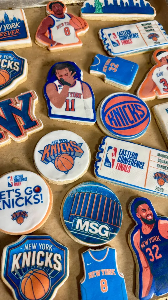 A collection of New York Knicks themed cookies, featuring player jerseys, logos, and an Eastern Conference Finals ticket.