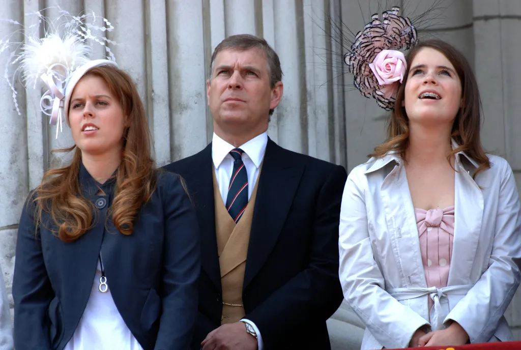Princess Beatrice, Prince Andrew, and Princess Eugenie on the balcony of Buckingham Palace.