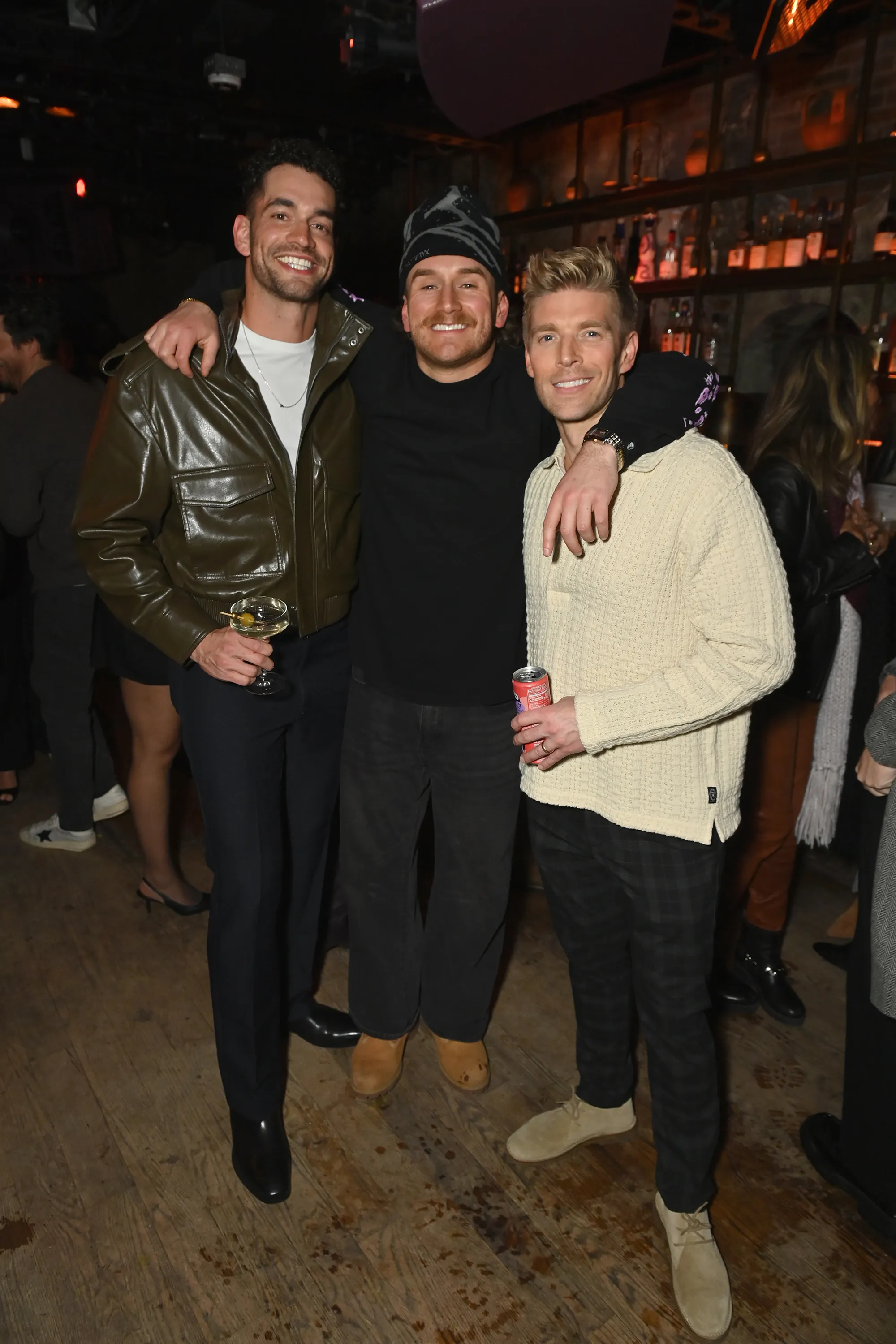 Jesse Solomon, West Wilson, and Kyle Cooke smiling and posing together at an event.