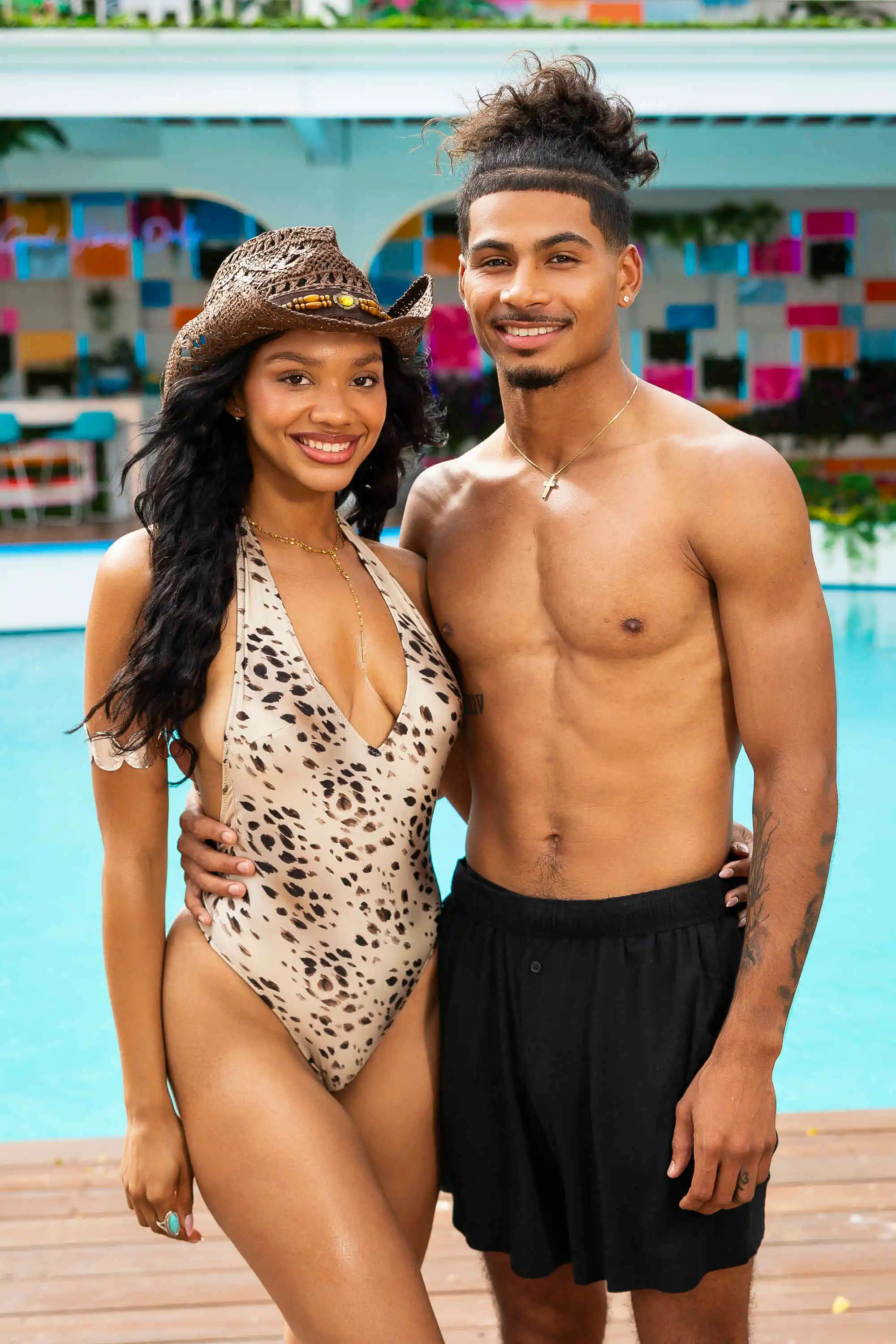 Melanie Moreno and Sincere Nicholas Rhea smiling by a pool.