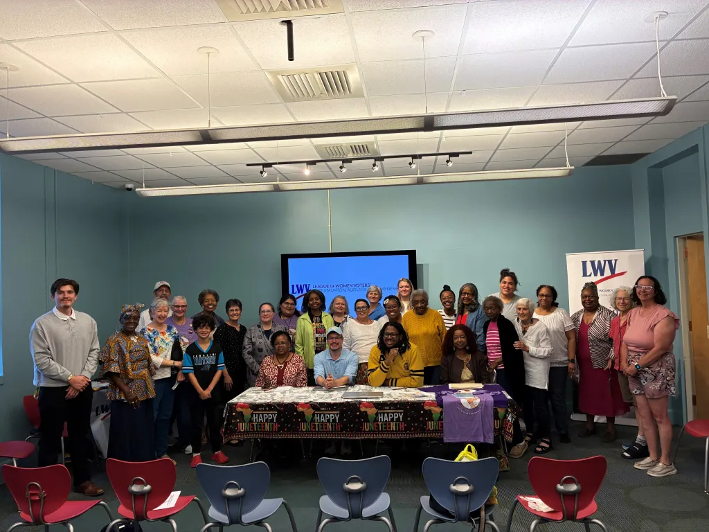 Group photo of people from the League of Women Voters and community members at a Juneteenth celebration.