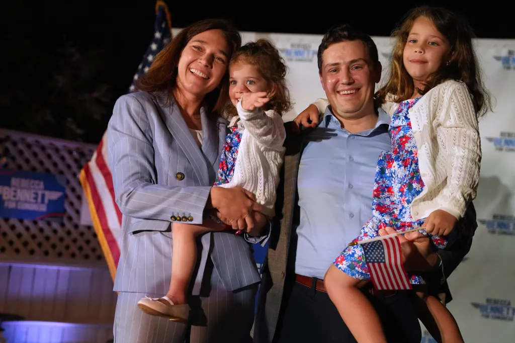 Rebecca Bennett, Democratic candidate for New Jersey's 7th Congressional District, holds her daughter Millie, alongside her husband Alex and daughter Rosie during a primary election night watch party.
