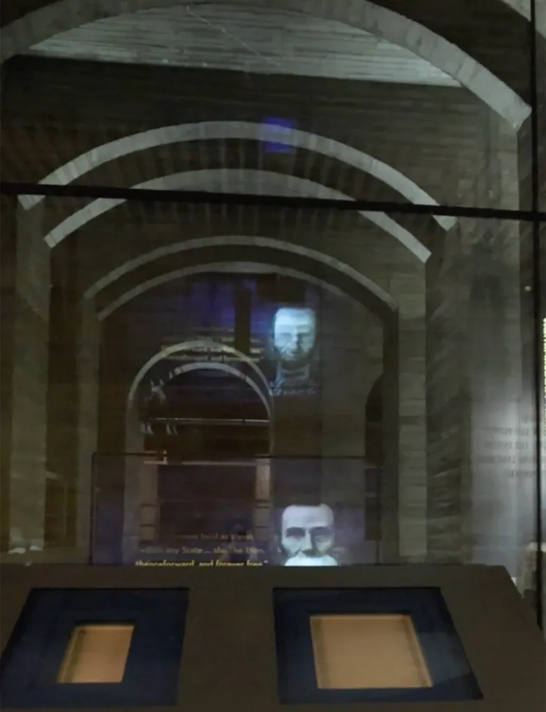 The Lincoln Memorial Undercroft with projections of Abraham Lincoln and text on the arched ceiling.
