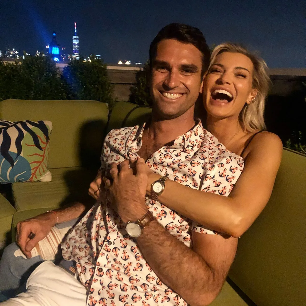 Lindsay Hubbard embracing Carl Radke from behind while both smile and laugh.