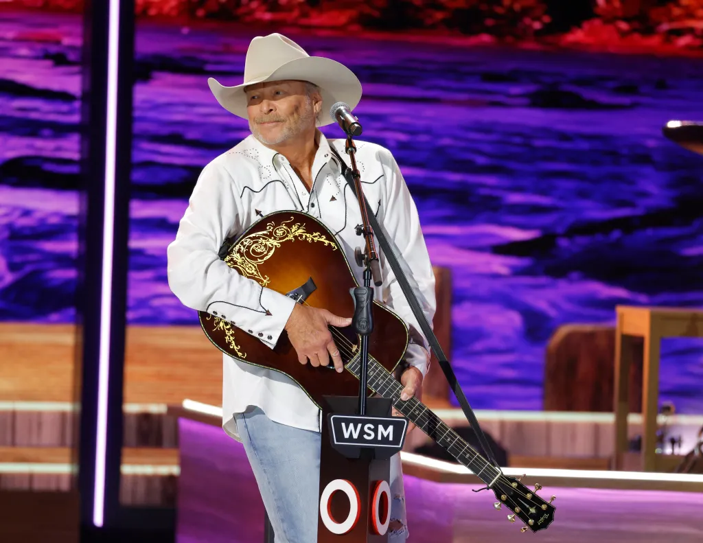 Alan Jackson performing onstage during Opry 100: A Live Celebration.