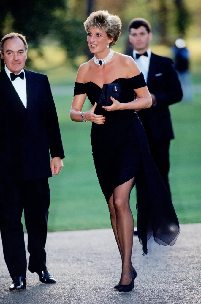 Princess Diana in a black off-the-shoulder dress with Lord Palumbo.