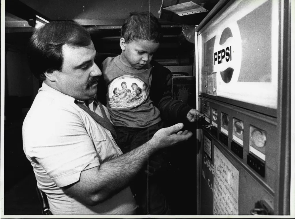 Transit det. Fred Mack and Unidentified Kid who was abandoned on the subway buy a soda Fri, morning. September 21, 1984. 