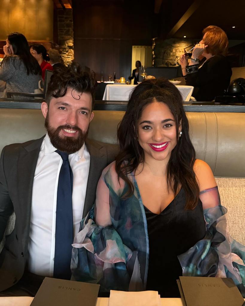Bliss Poureetezadi and Zack Goytowski smiling while seated at a restaurant.