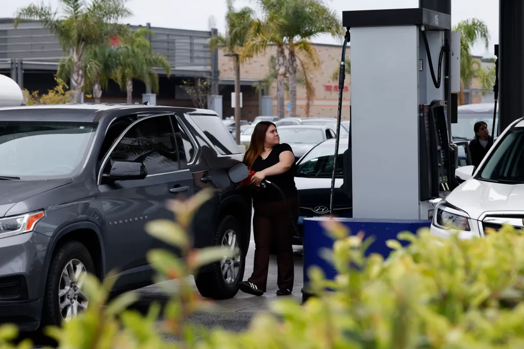 Woman filling up on gas.