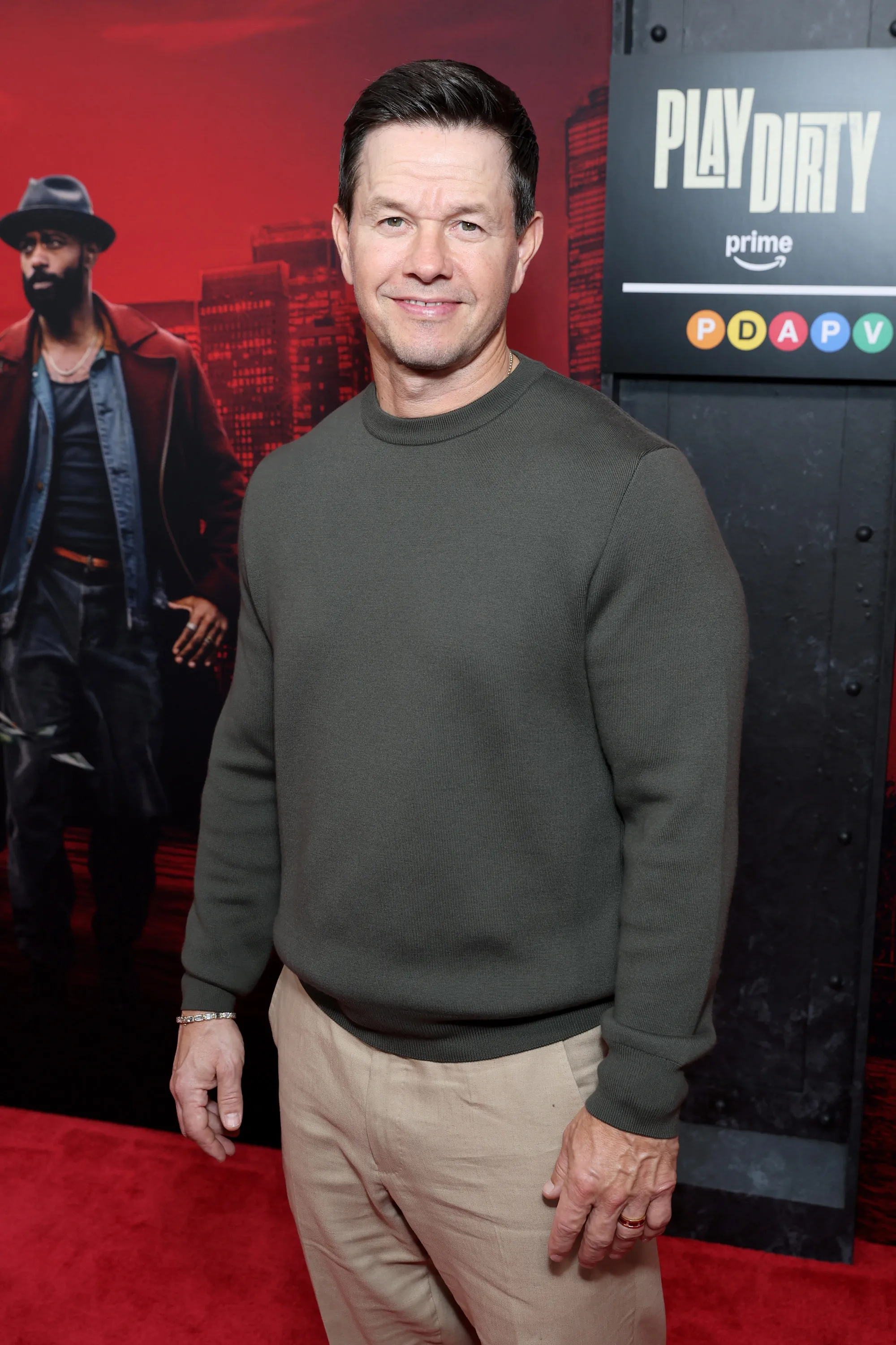 Mark Wahlberg smiles on the red carpet at the 