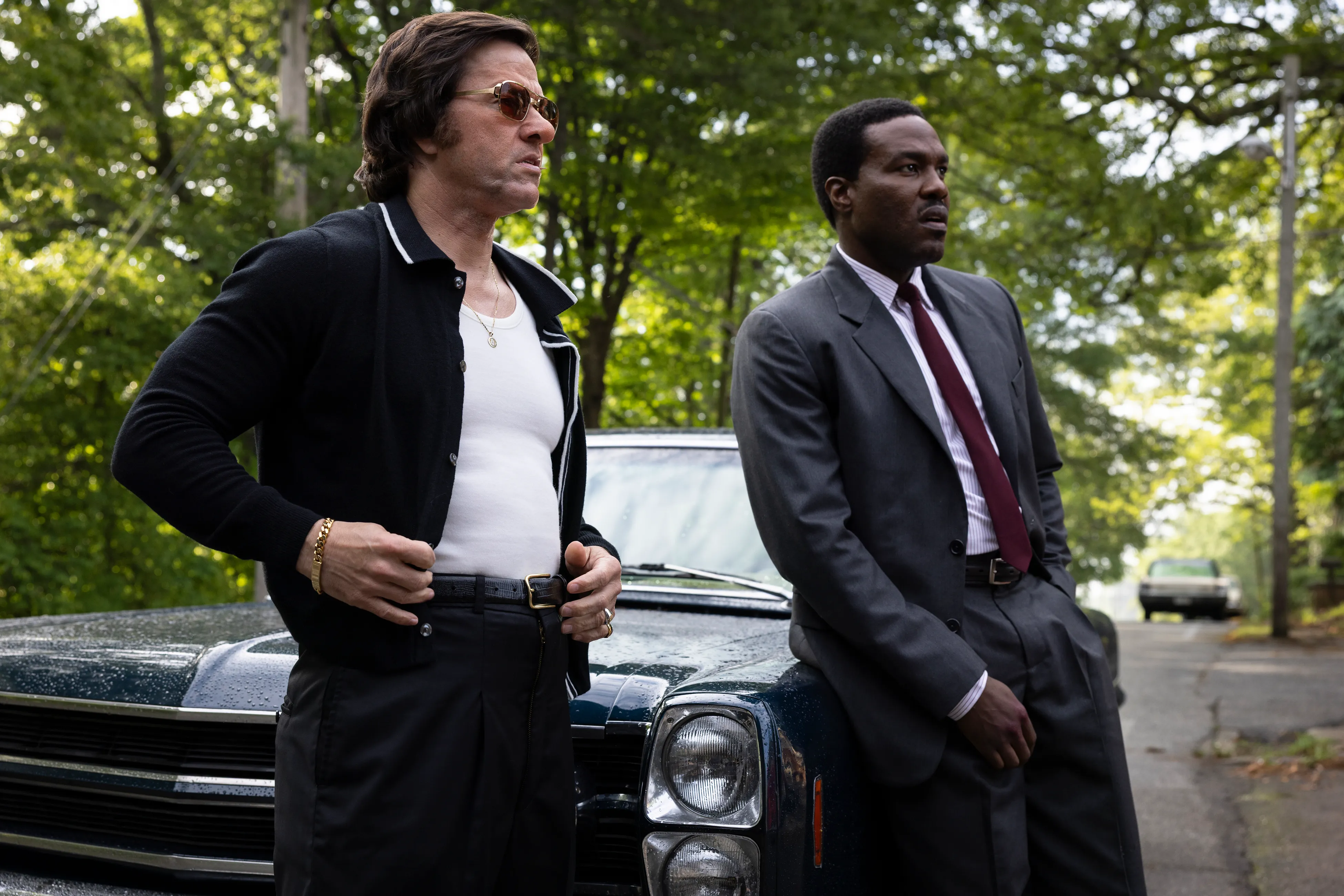 Mark Wahlberg and Yahya Abdul-Mateen II standing next to a car.