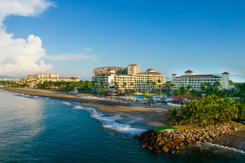 Aerial view of the Marriott Puerto Vallarta Resort and Spa with its buildings, beach, and ocean.