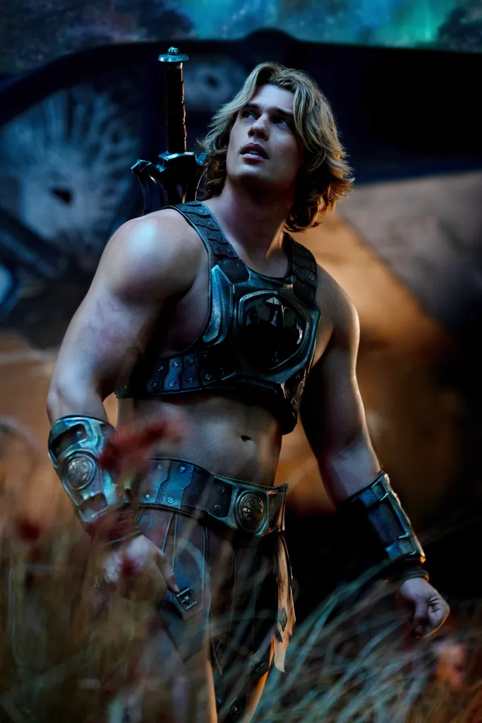 Nicholas Galitzine as Adam/He-Man wearing armor and carrying a sword.