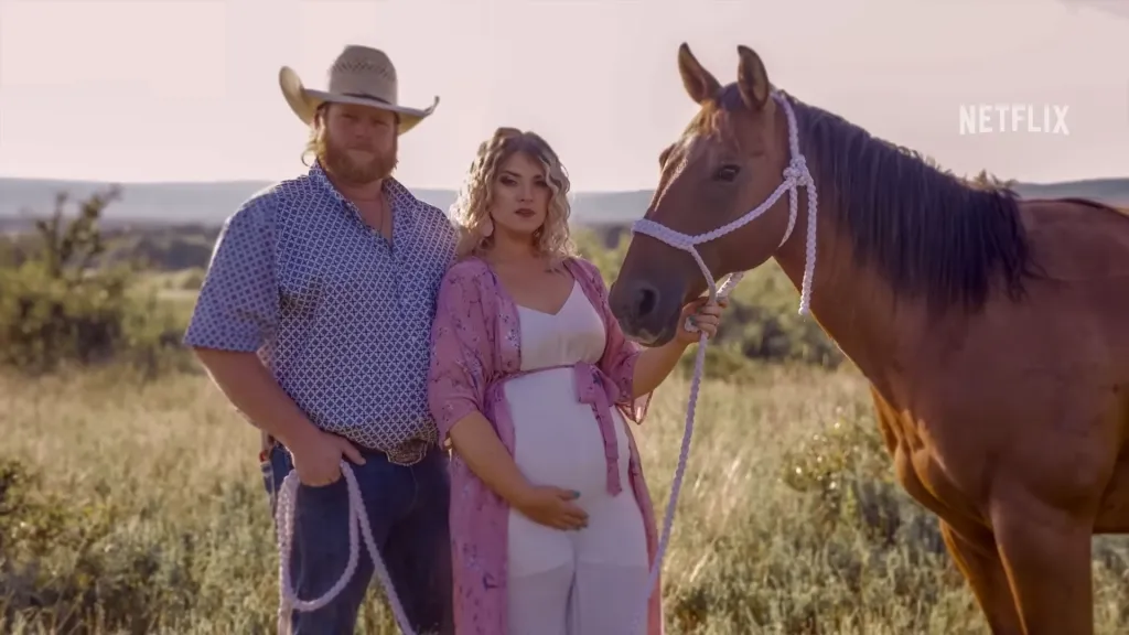 Taylor Parker (pregnant woman) with a man and horse in a field.