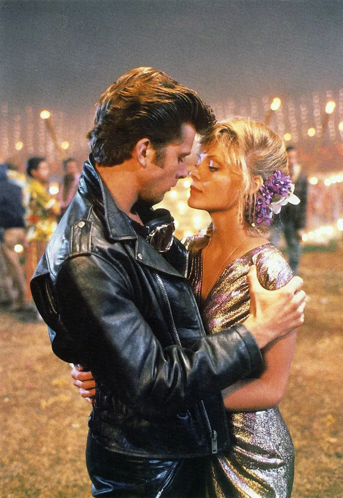 Maxwell Caulfield and Michelle Pfeiffer nose-to-nose in Grease 2.