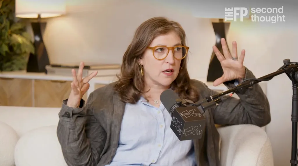 Mayim Bialik speaking into a microphone.