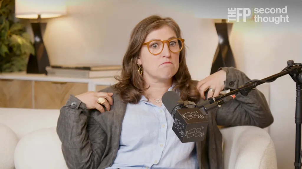 Mayim Bialik speaking into a microphone.