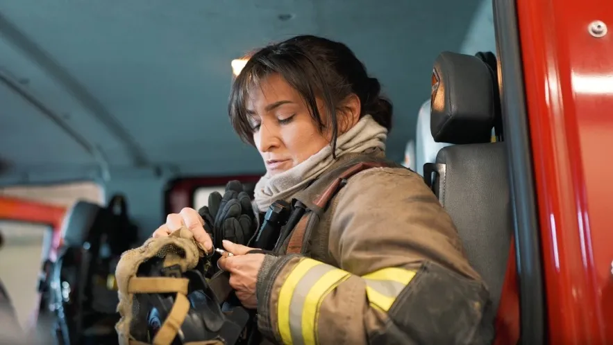 Priscilla Charris, an incarcerated firefighter, preparing for duty.