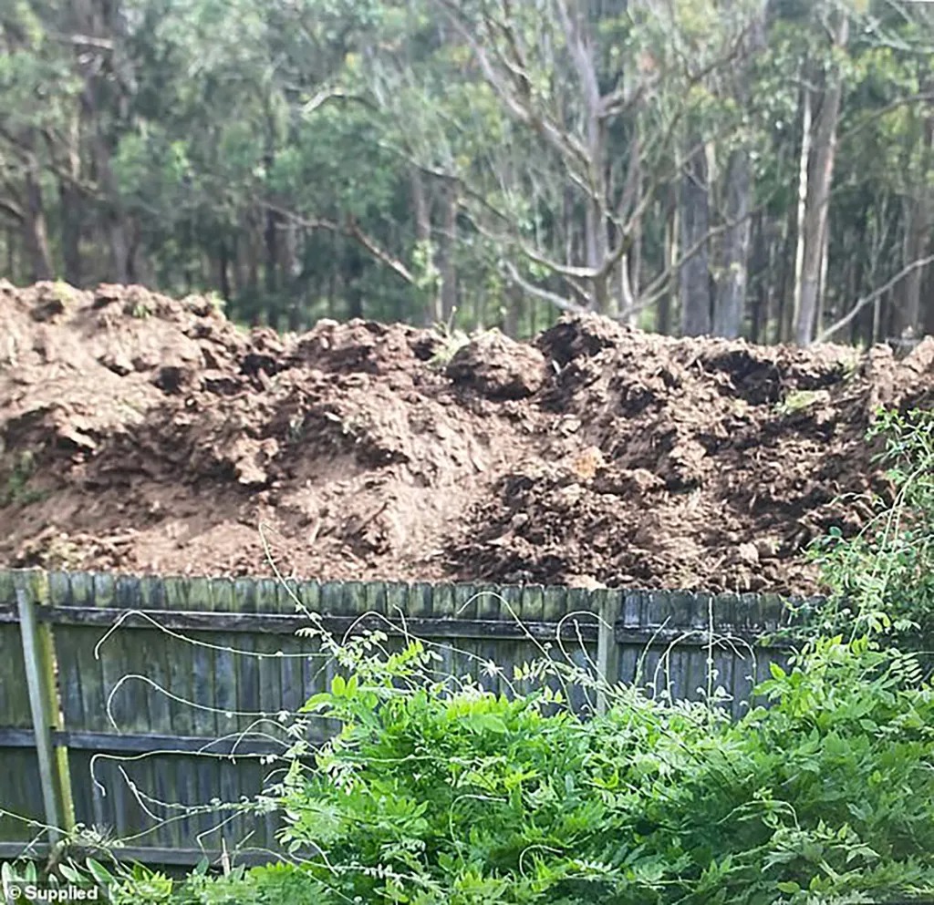 An Australian mother of five says she is trapped in her home after her wealthy neighbors erected a 10-foot wall of dirt and manure around her property, leaving her with a house she cannot sell.
