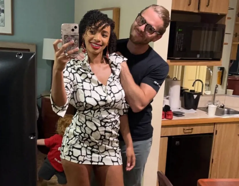 Michaela Rylaarsdam taking a selfie with Michael Dale in a kitchen.