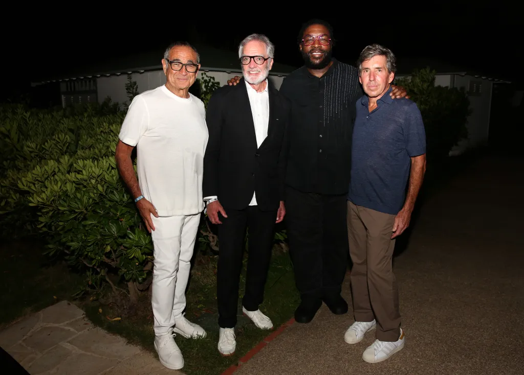 Michael Kassan, Bob Pittman, Questlove, and Rich Bressler posing together at an after-party.