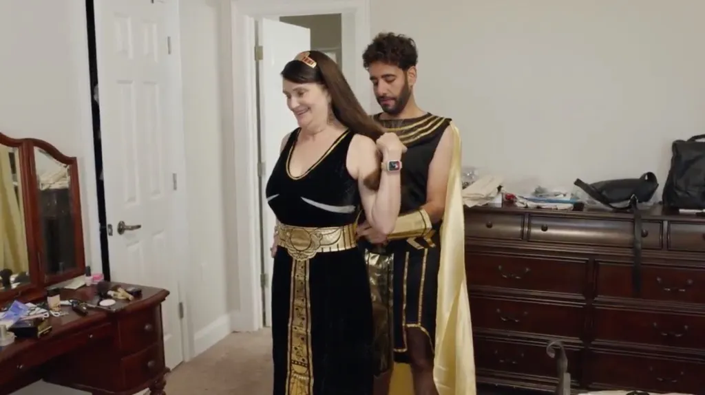 Mido helping Debby dress in Egyptian costumes.