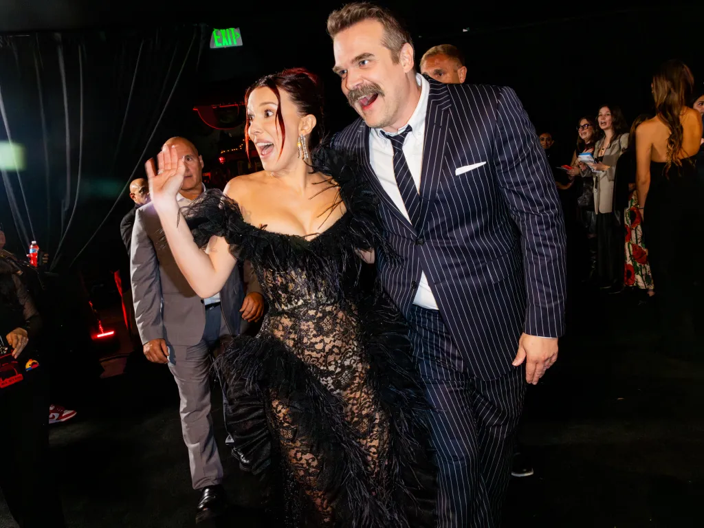 Millie Bobby Brown and David Harbour posing at the premiere of 