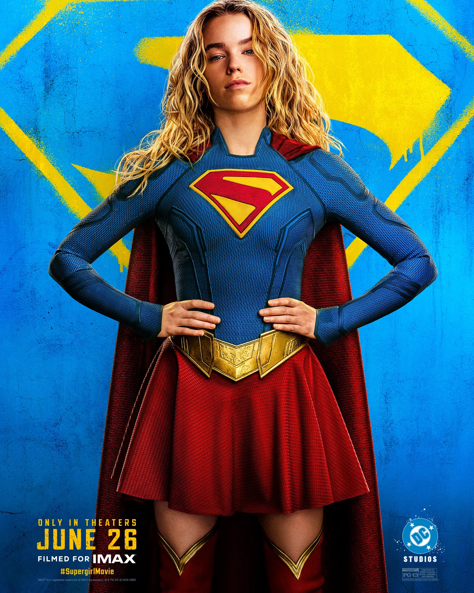 Milly Alcock as Supergirl in a blue and red suit with a yellow S-shield, standing against a blue and yellow background.