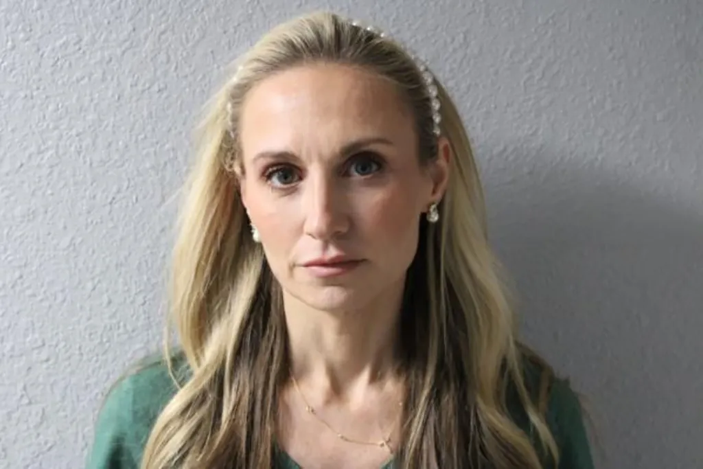 Misty Roberts wears a pearl headband and pearl earrings in 2026 mugshot