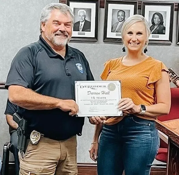 Misty Roberts and Police Department Deputy Chief Darren Hall posing with a certificate.