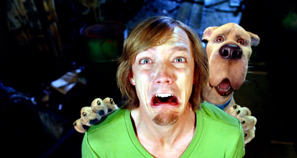 Matthew Lillard as Shaggy and Scooby-Doo screaming in fear.