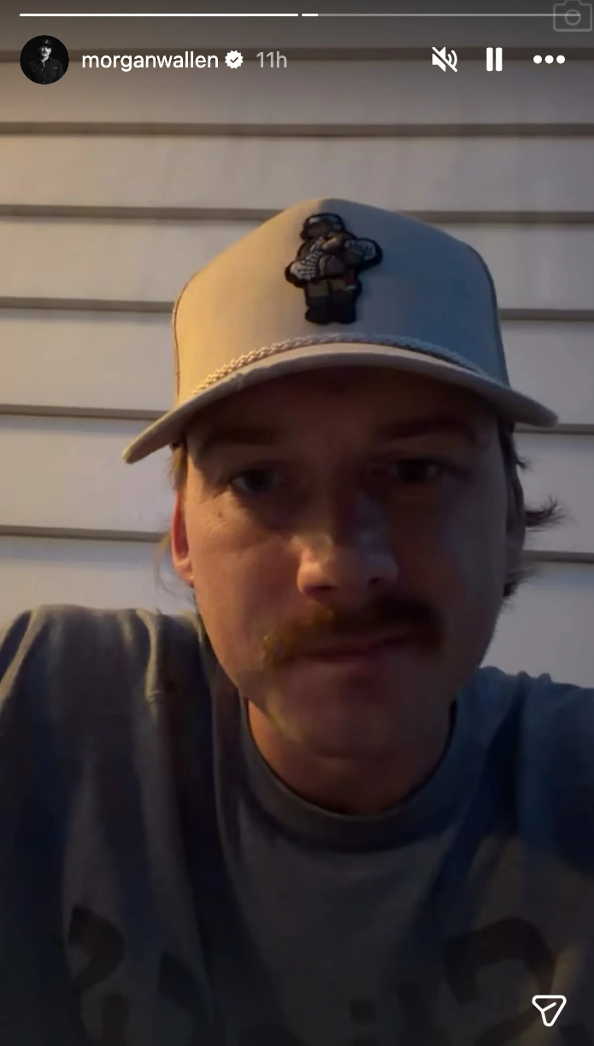 Morgan Wallen speaking to the camera in a light-colored baseball cap and a t-shirt.