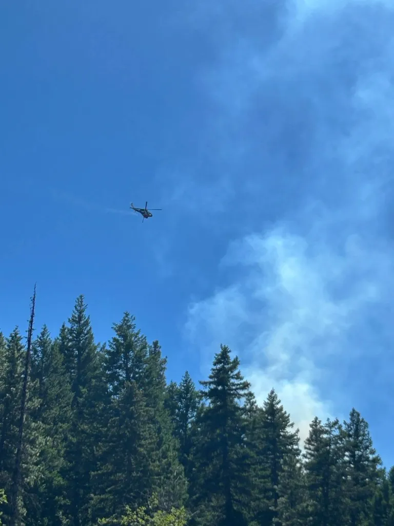 Helicopter flying over a forest fire.