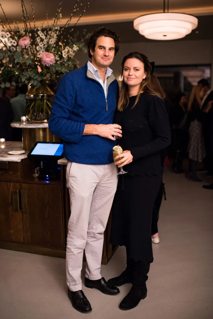 Natasha Rufus Isaacs and Rupert Finch attending a party.