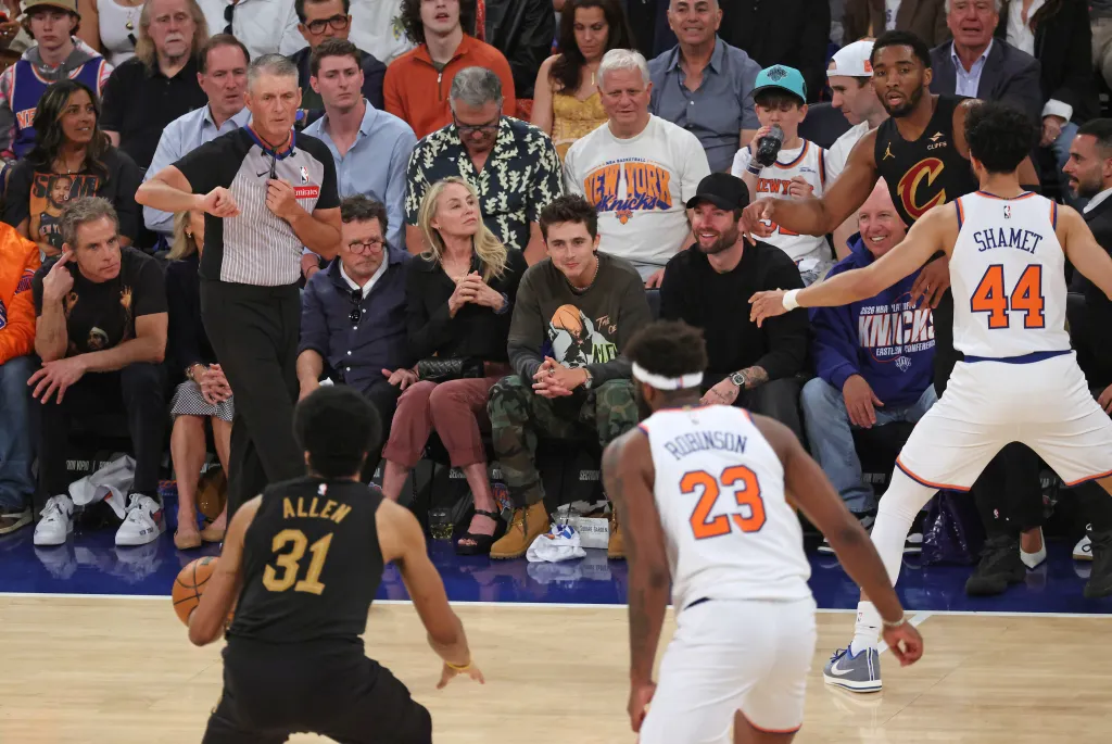 Actors Ben Stiller, Christine Taylor, Michael J. Fox, and Timothée Chalamet sit courtside at an NBA Eastern Conference Finals game.