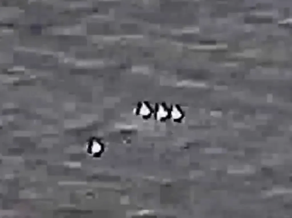 A declassified image shows a UFO in flight against the sky. 
