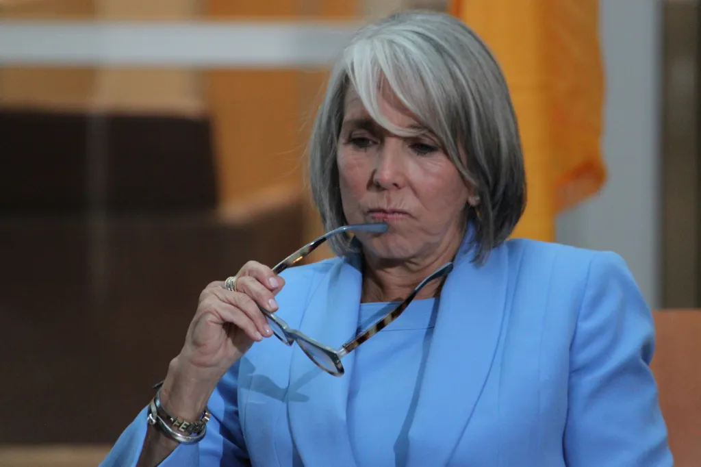 New Mexico Gov. Michelle Lujan Grisham listens as law enforcement authorities speak during a news conference in Albuquerque, on Monday, June 29, 2026. 