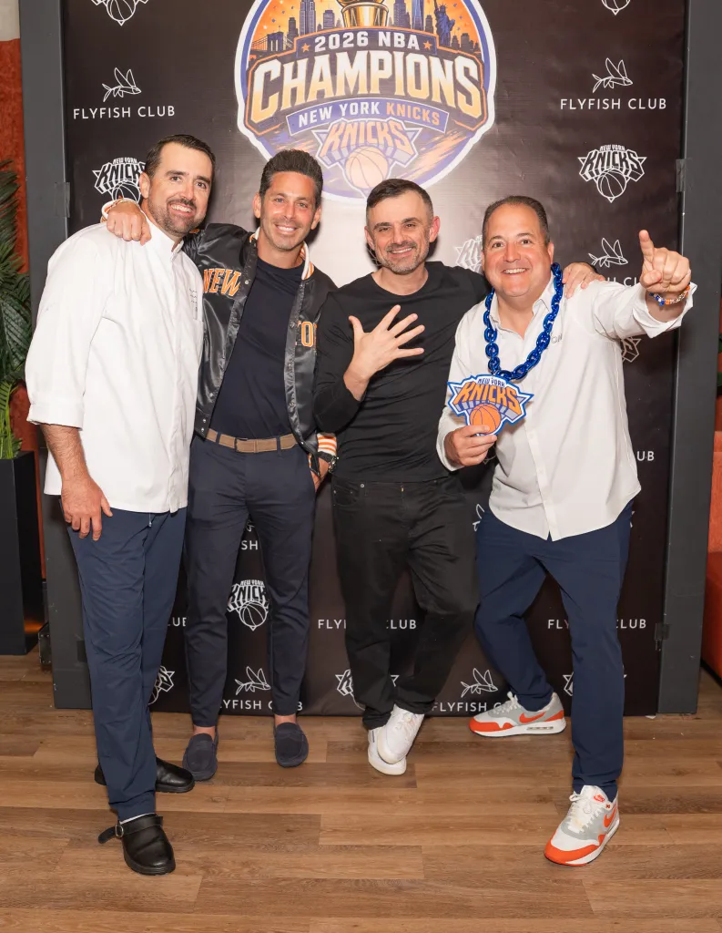 Four men celebrating with a 