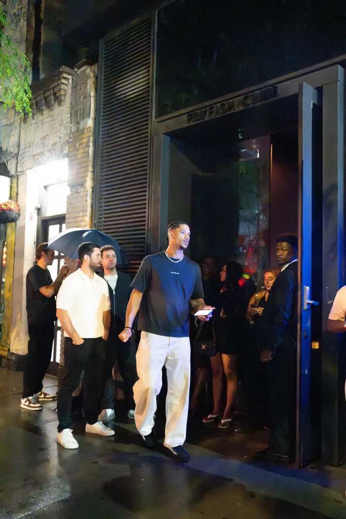 Jalen Brunson leaving the Flyfish Club with Mikal Bridges, Karl-Anthony Towns, and other New York Knicks players.