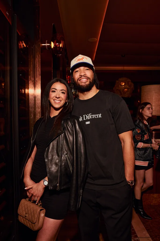 Jalen Brunson and Jordyn Woods posing together at the New York Knicks NBA Championship celebration.