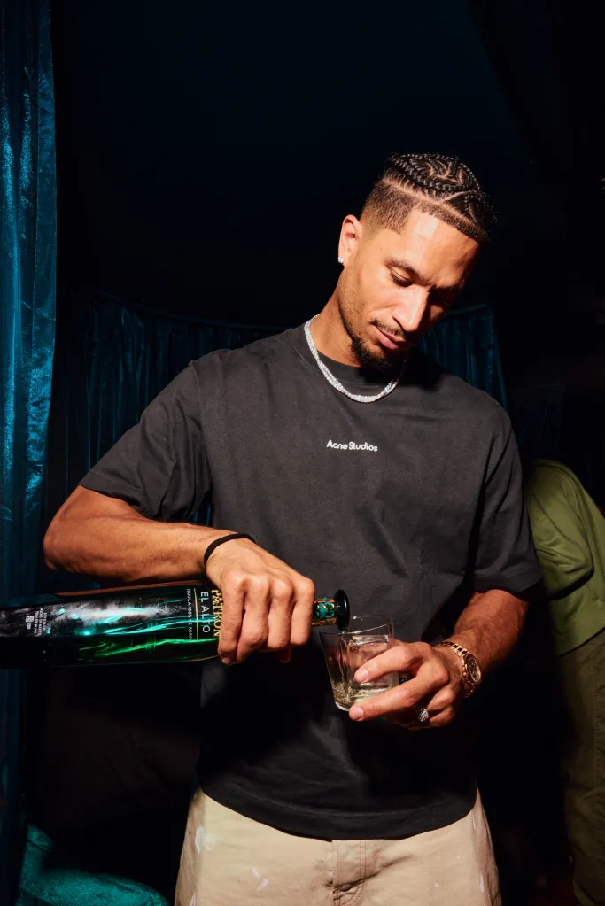 Josh Hart pouring Patron El Alto tequila into a glass.