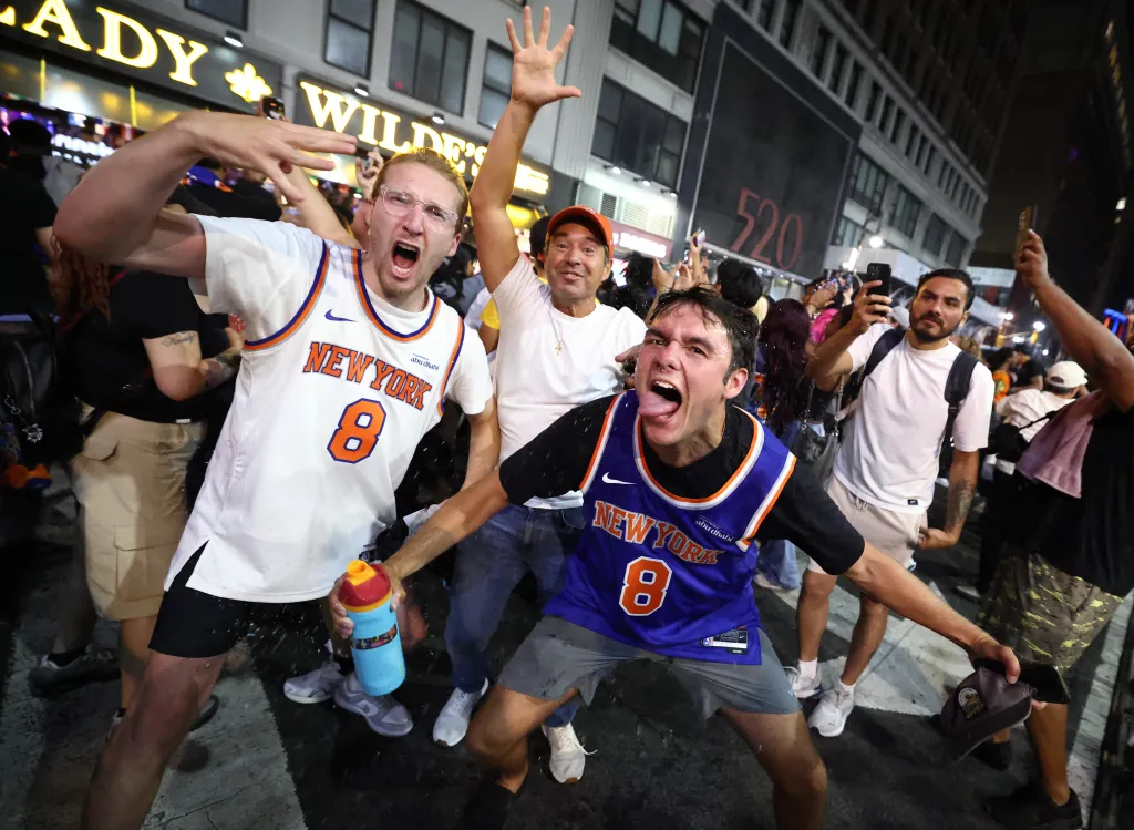 New York Knicks fans celebrate their team's Game 4 victory over the San Antonio Spurs in the NBA Finals.