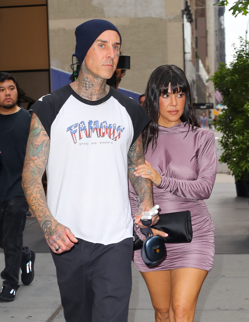 Kourtney Kardashian and Travis Barker holding hands while leaving the Aman Hotel in New York.