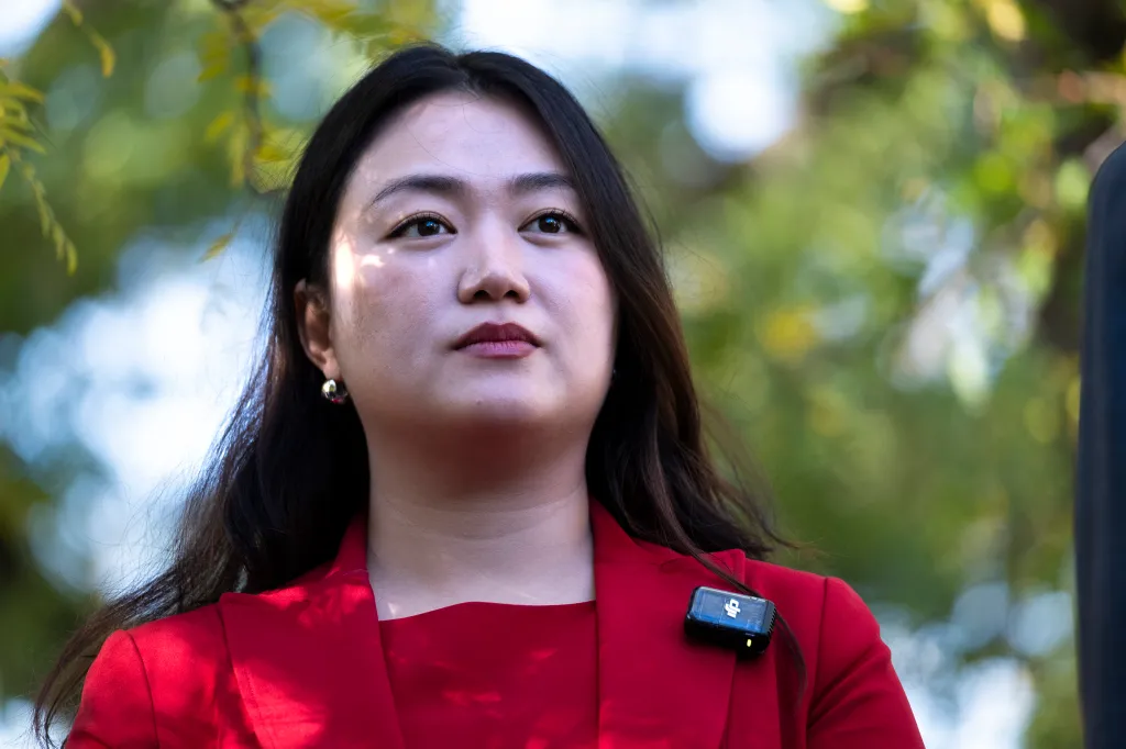 City Council member Julie Won in a red jacket.