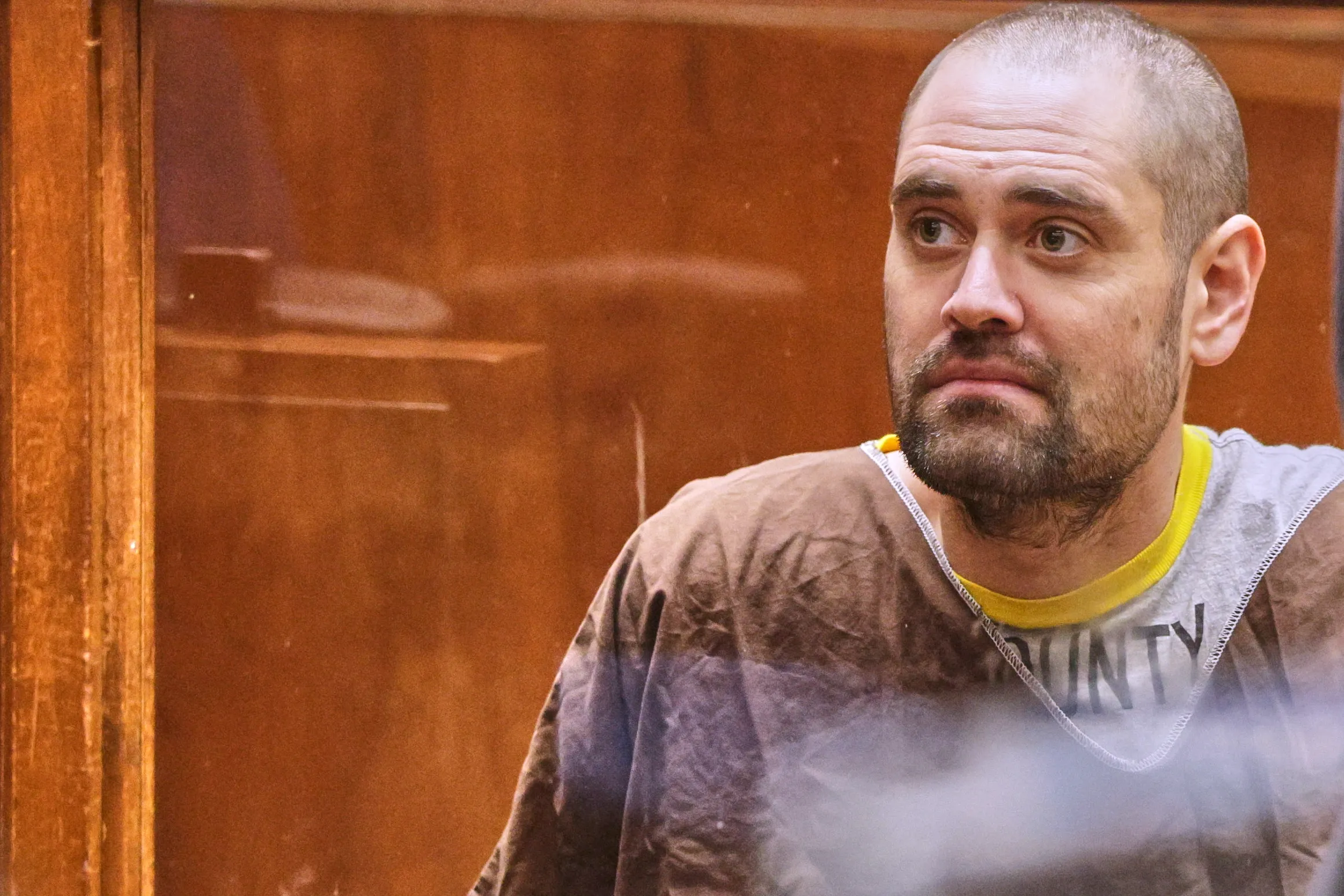 Nick Reiner, accused of murder, looks over his shoulder during his arraignment.